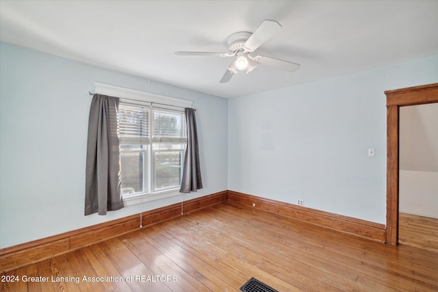 unfurnished room featuring hardwood / wood-style floors and ceiling fan