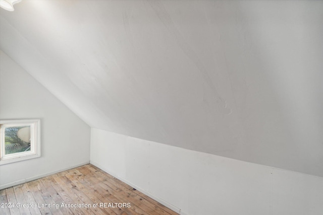 bonus room with light hardwood / wood-style flooring and lofted ceiling