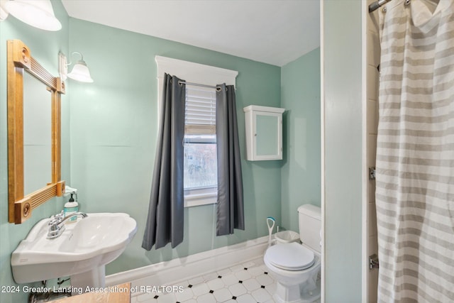 bathroom with a shower with shower curtain, tile patterned flooring, toilet, and sink