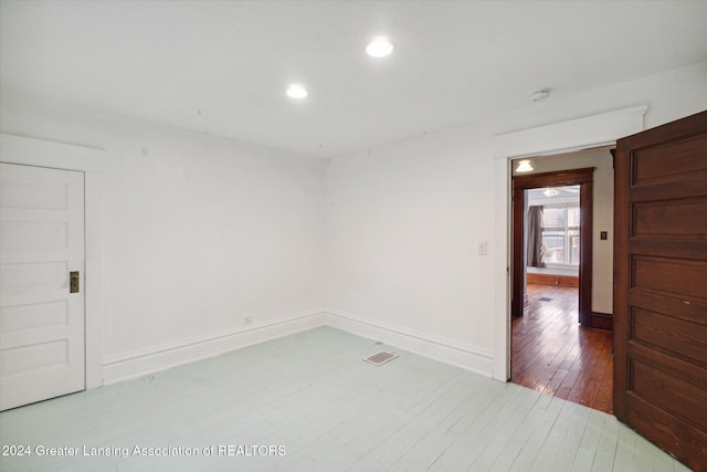 empty room with hardwood / wood-style floors