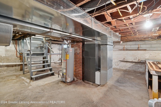 basement featuring heating unit and water heater