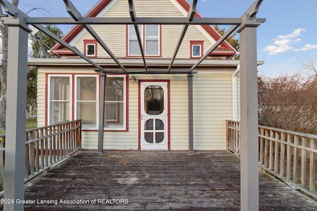 rear view of property featuring a deck