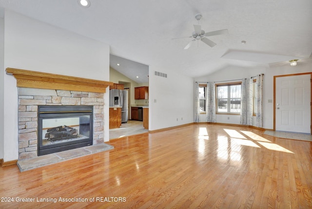 unfurnished living room with a fireplace, light hardwood / wood-style flooring, vaulted ceiling, and ceiling fan