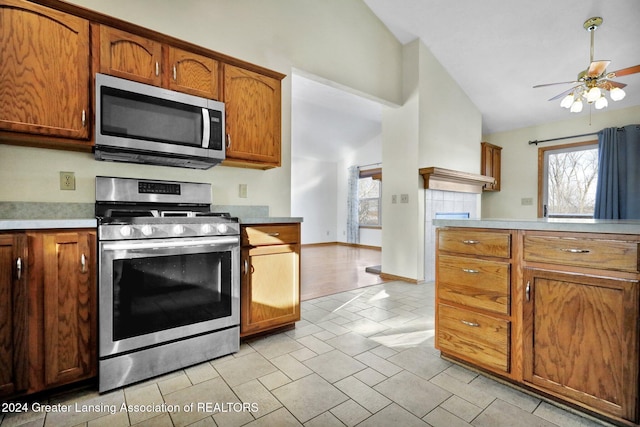 kitchen featuring appliances with stainless steel finishes, high vaulted ceiling, and ceiling fan