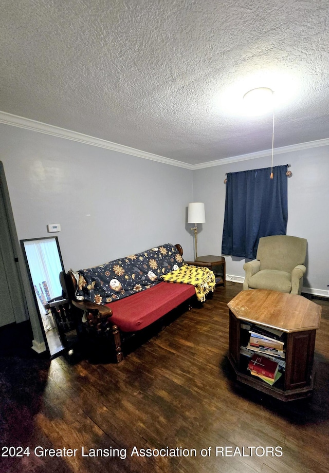 living room with crown molding, dark wood-type flooring, and a textured ceiling