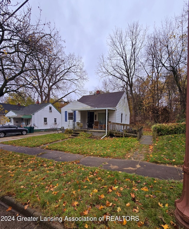 bungalow-style home with a porch and a front yard