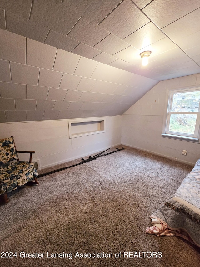 bonus room with carpet floors and vaulted ceiling