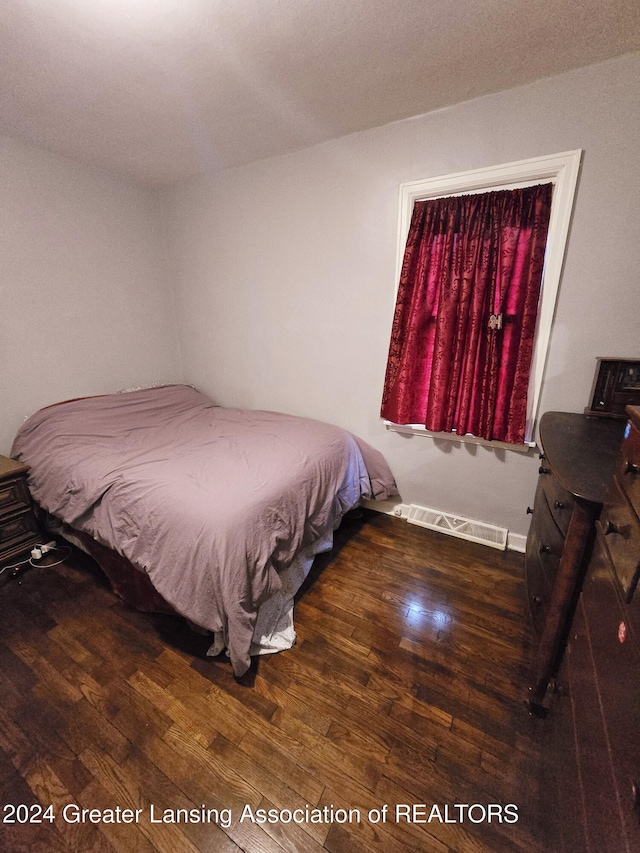 bedroom featuring dark hardwood / wood-style flooring