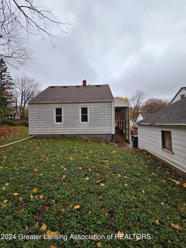 rear view of property with a lawn