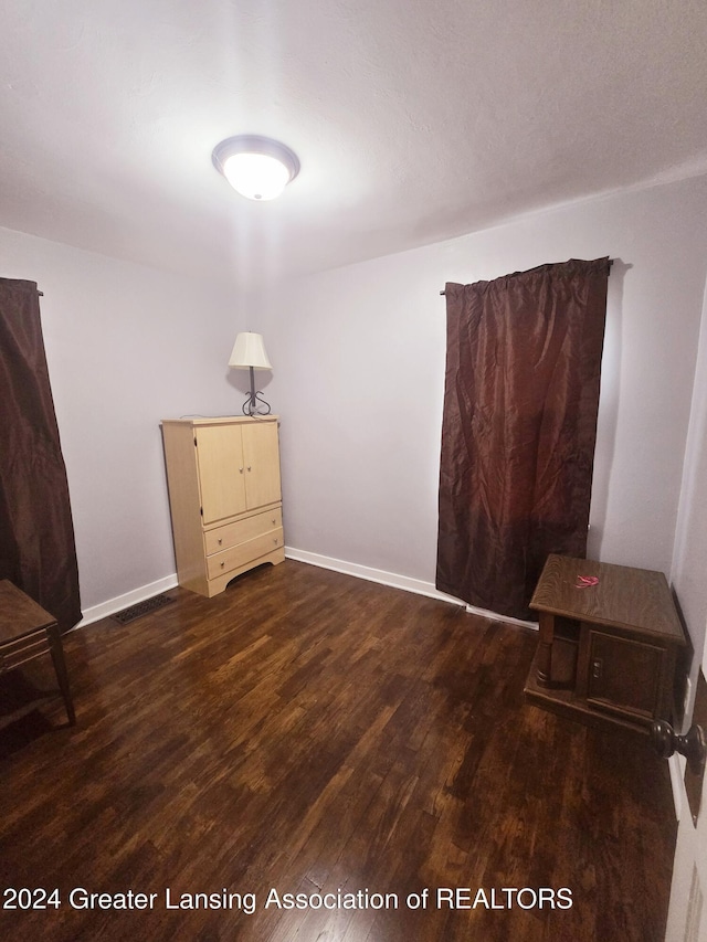 unfurnished room featuring dark hardwood / wood-style flooring