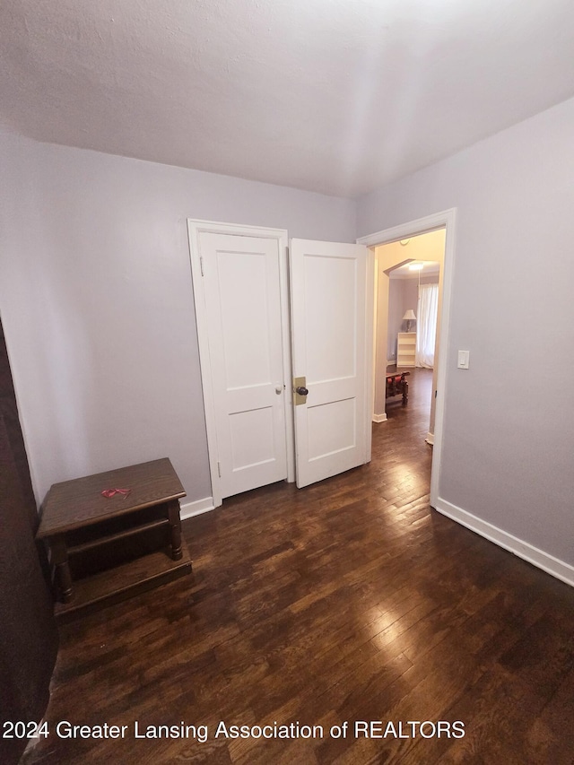 empty room featuring dark hardwood / wood-style flooring