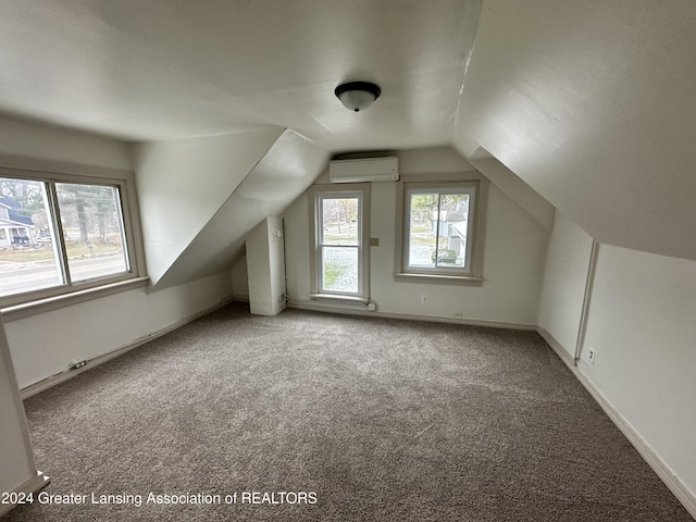 additional living space featuring carpet flooring, an AC wall unit, and vaulted ceiling