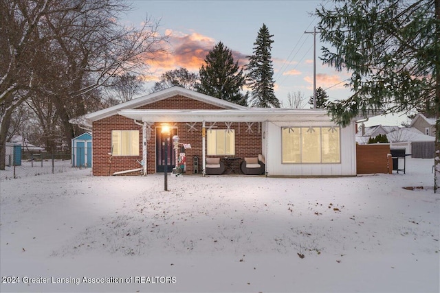 view of front of home with a shed