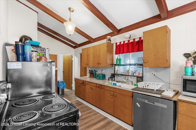 kitchen featuring sink, vaulted ceiling with beams, dark hardwood / wood-style flooring, pendant lighting, and appliances with stainless steel finishes