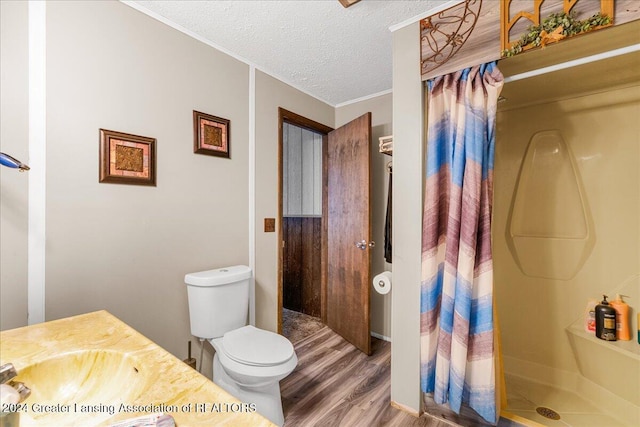 bathroom with a shower with shower curtain, wood-type flooring, a textured ceiling, and vanity