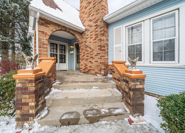 view of snow covered property entrance