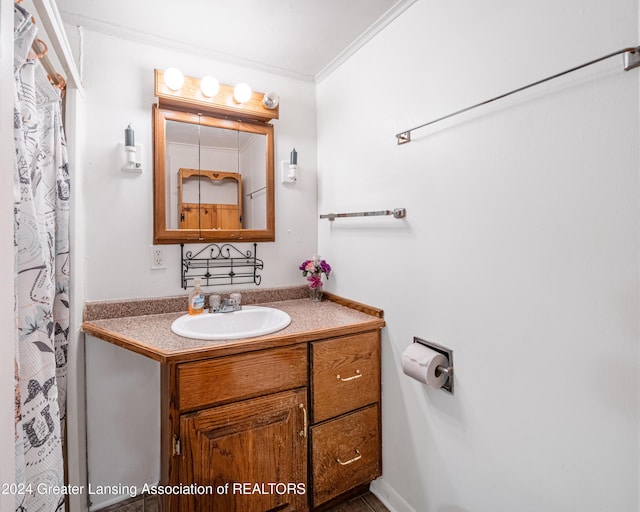 bathroom with vanity and ornamental molding