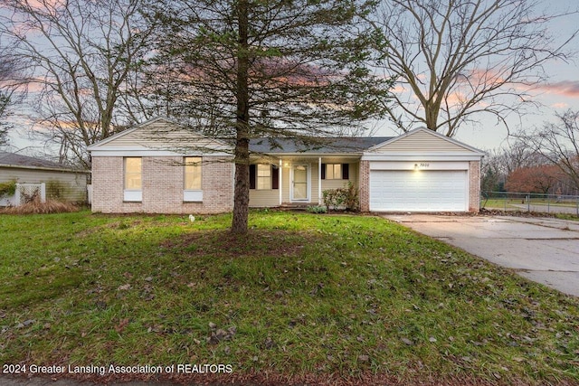 view of front of house with a yard and a garage