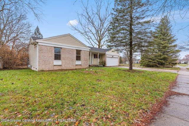 view of front of house with a front yard and a garage