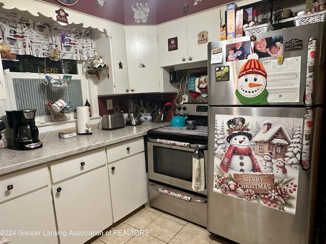 kitchen featuring white cabinets, light tile patterned floors, and appliances with stainless steel finishes