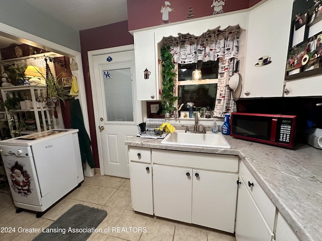 kitchen with white refrigerator, white cabinetry, sink, and light tile patterned floors