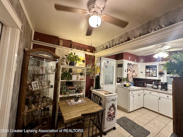 kitchen featuring white cabinets, light tile patterned floors, and a textured ceiling