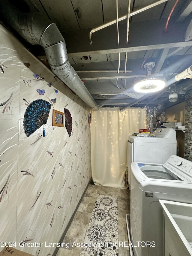 basement with washing machine and clothes dryer and sink