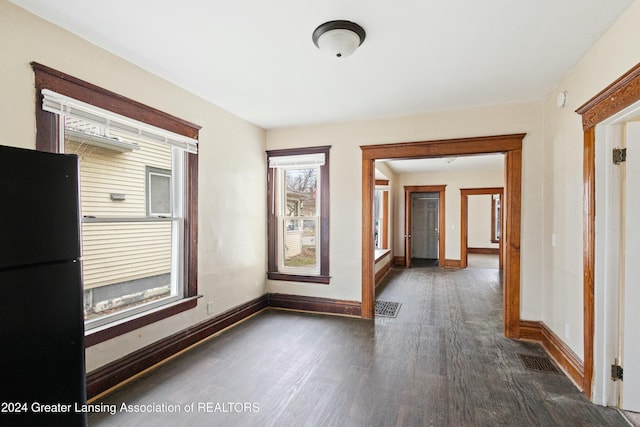 empty room with dark wood-type flooring