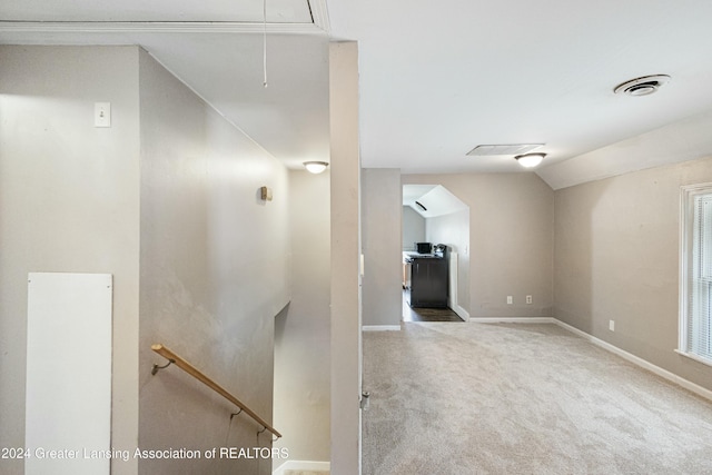 interior space featuring carpet and vaulted ceiling