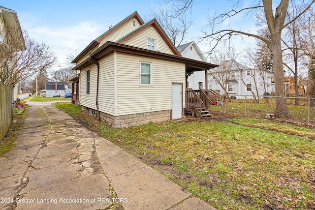 view of property exterior with a lawn