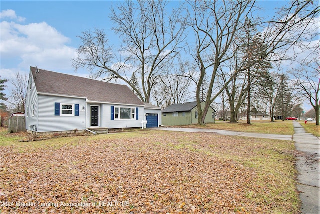 view of front facade with an outbuilding and a garage