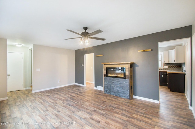 unfurnished living room featuring ceiling fan and light hardwood / wood-style floors