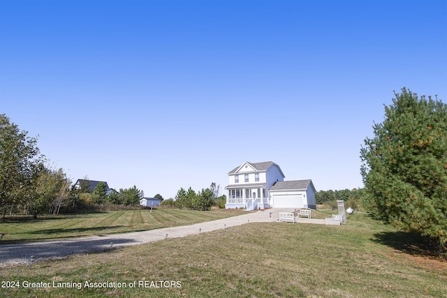 view of front of property featuring a garage and a front lawn