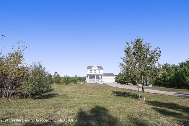 view of front facade with a garage and a front lawn