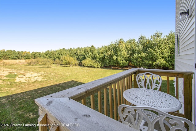 wooden terrace with a lawn