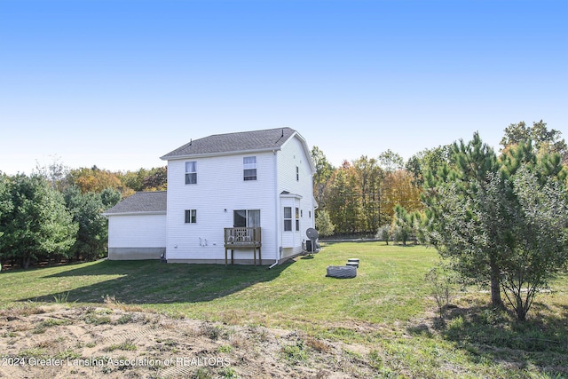 back of property featuring a yard