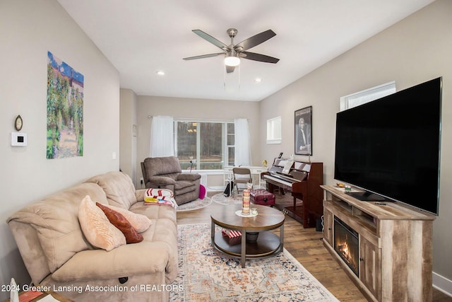 living room with ceiling fan and hardwood / wood-style flooring