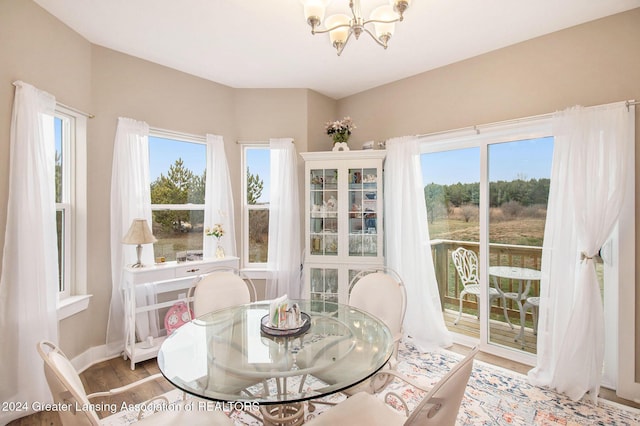 sunroom / solarium featuring a notable chandelier