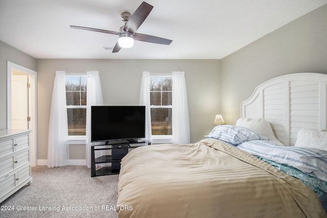 bedroom featuring ceiling fan and light carpet