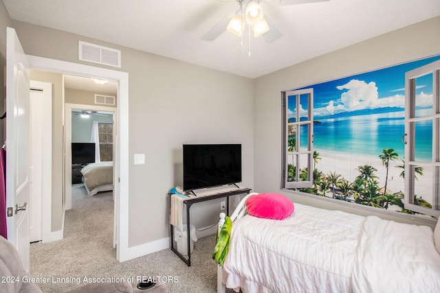 bedroom with ceiling fan and light carpet