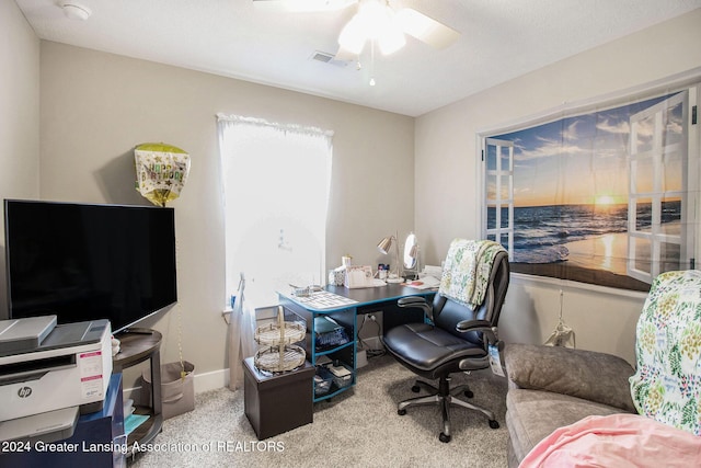 office area with ceiling fan and light carpet