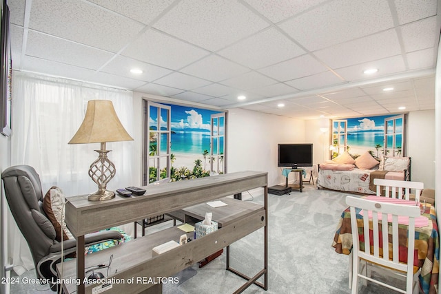 carpeted living room with a paneled ceiling