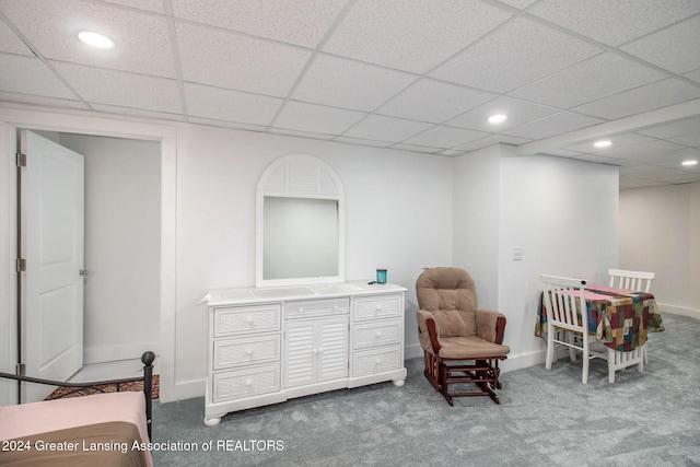 sitting room featuring a paneled ceiling and carpet floors