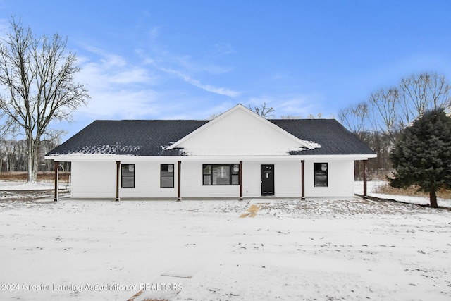 view of snow covered rear of property