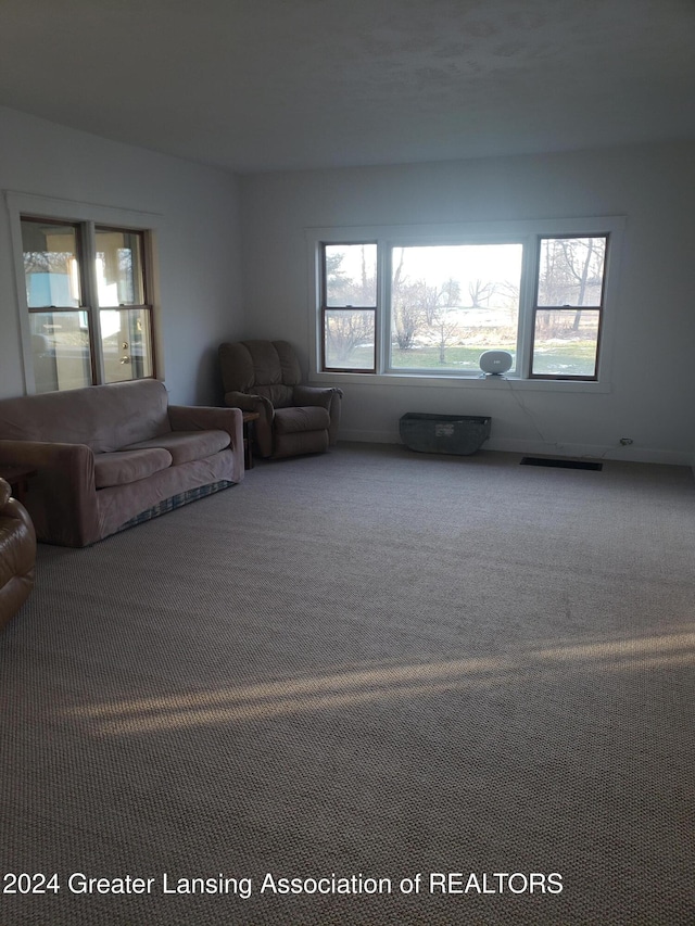 unfurnished living room featuring carpet flooring