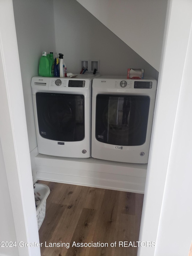 laundry room featuring washing machine and dryer and dark wood-type flooring