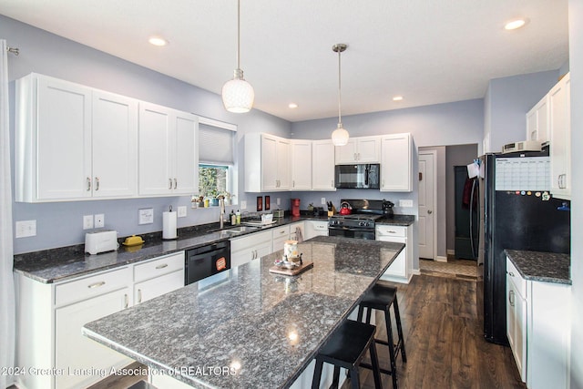 kitchen with white cabinetry, pendant lighting, and black appliances