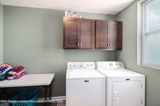 laundry area featuring cabinets, independent washer and dryer, and a textured ceiling