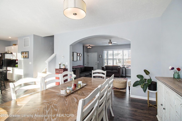 dining area with ceiling fan, dark hardwood / wood-style floors, and a textured ceiling