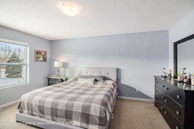 carpeted bedroom with a textured ceiling